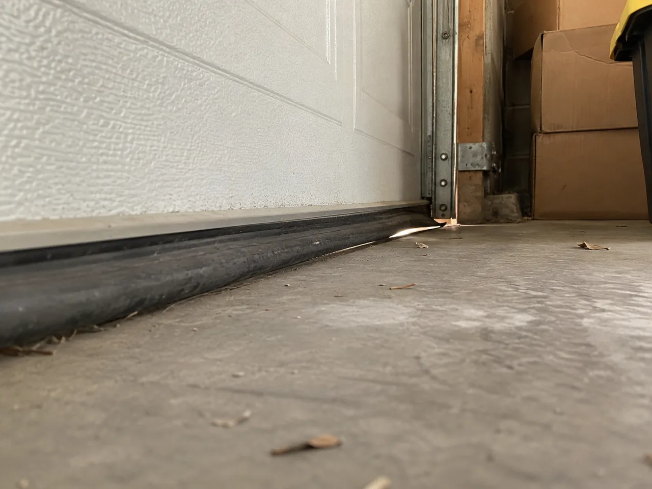 Garage threshold and stored boxes in a Palmdale-style home during cool-season daylight